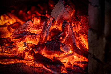 Flame of fire from hot burning coals in the fireplace. Heat from the oven. 