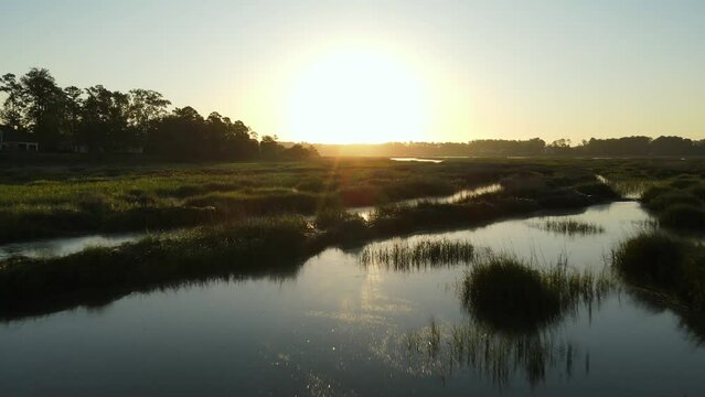 2022 - Excellent aerial footage moving over marshlands towards the sunset in South Carolina.