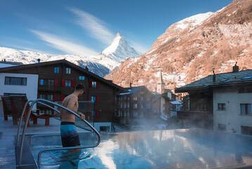 Luxury infinity outdoors pool with an amazing view at the Matterhorn peak in Zermatt, Switzerland. 
