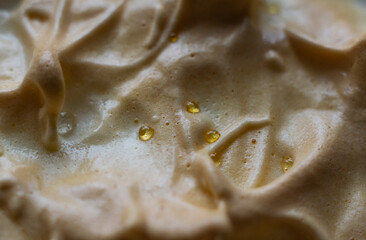 Tartlet with Italian meringue and lemon cream on a black bacmground, selective focus.
Top view. 