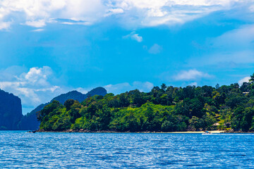 Tropical paradise turquoise water beach and limestone rocks Krabi Thailand.