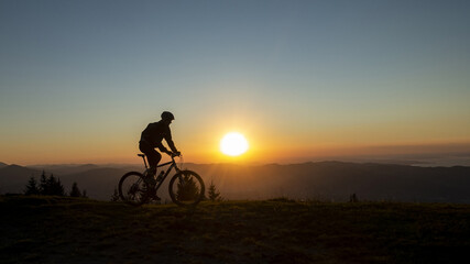 silhouette of a mountain biker towards a wonderful sunset