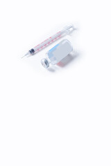 Vaccine vial and syringe isolated on white background. Coronavirus Vaccine. Top view