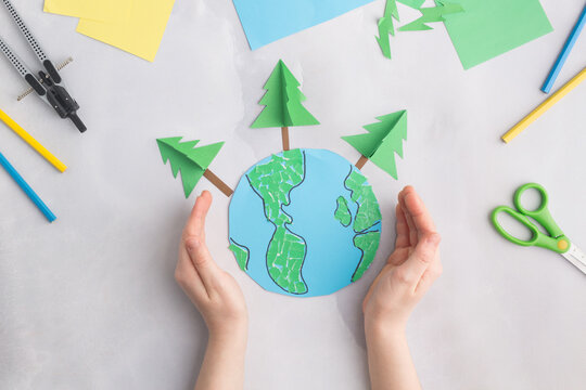 earth cut from paper around trees earth day concept kid's paper craft