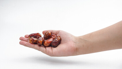 Hand holding Middle Eastern dates over white background. selective focus
