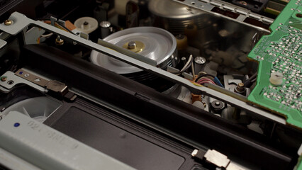 VHS video cassette recorder pull out from VCR player. Tape play video file or movie. VHS mechanics video cassette player take off tape head. Vintage concept.