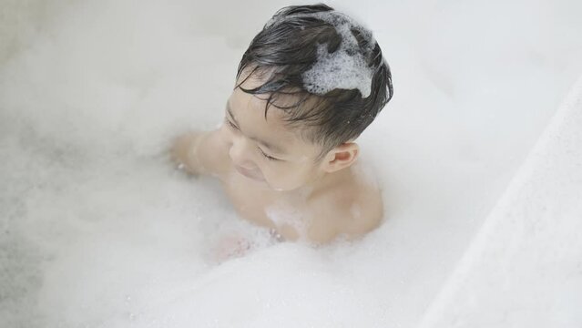boy taking a bath in the tub take bath he plays with bubbles