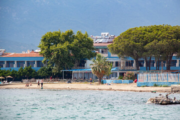 Fototapeta na wymiar View from the Aegean sea to the shore of Turkey. Houses on the coast of the Aegean Sea