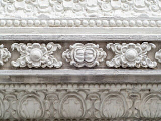 Fototapeta na wymiar white thai flower pattern on white wall for decorate