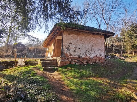 an old abandoned house, made of mud, clay, wood and stone. building from natural materials