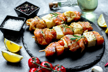 raw salmon skewers on skewers on a stone background.Raw seafood on skewers