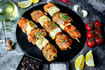 raw salmon skewers on skewers on a stone background.Raw seafood on skewers