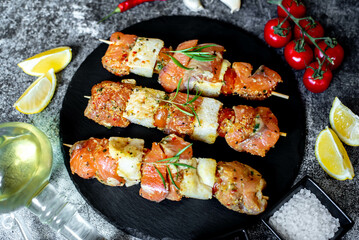 raw salmon skewers on skewers on a stone background.Raw seafood on skewers