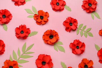 Paper poppy flowers with leaves on pink background