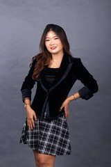 Asian Chinese women in formal office wear wear jackets and skirts. smiling girl expression posing formal sexy her hand holding a suit all elegant