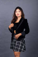 Asian Chinese women in formal office wear wear jackets and skirts. arrogant girl expression posing formal sexy her hands holding a jacket up and down