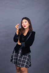 beautiful chinese asian women dressed in formal office wear jackets and skirts. girl expression pouting thin formal pose her hands showing love sign Saranghaeyo Saranghae