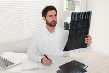Doctor examining neck MRI scan in hospital