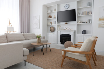 Cozy room interior with stylish furniture, decorative fireplace and TV set