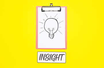 Clipboard with drawn light bulb and word INSIGHT on yellow background