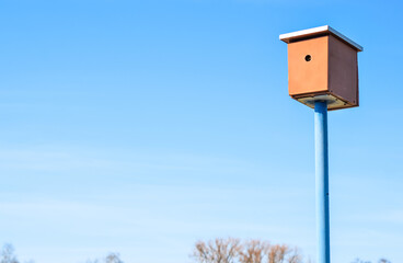 View of wooden bird house against blue sky
