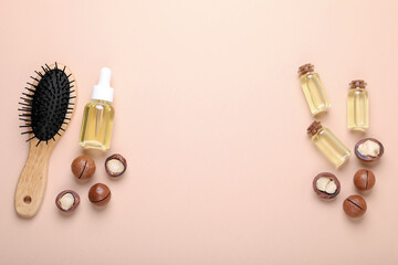 Delicious organic Macadamia nuts, cosmetic oil and brush on beige background, flat lay. Space for text
