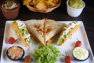 Mexican food tacos, fried chicken, greens, mango, avocado, pepper, red cabbage in tex-mex mix tortillas