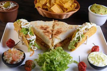 Mexican food tacos, fried chicken, greens, mango, avocado, pepper, red cabbage in tex-mex mix tortillas