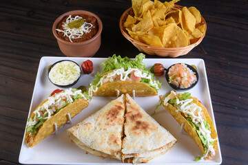 Mexican food tacos, fried chicken, greens, mango, avocado, pepper, red cabbage in tex-mex mix tortillas