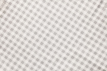 Beige checkered tablecloth as background, top view