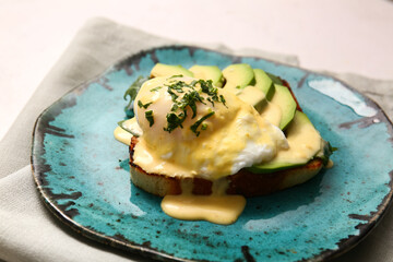 Plate with tasty egg Benedict on white table, closeup