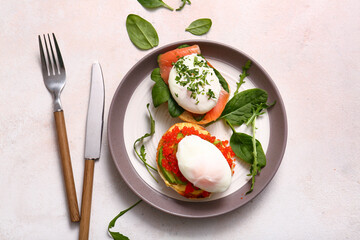 Plate with tasty eggs Benedict on white table