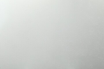 Light gray textured surface as background, top view