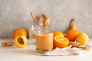 Glass of healthy smoothie and ingredients on table