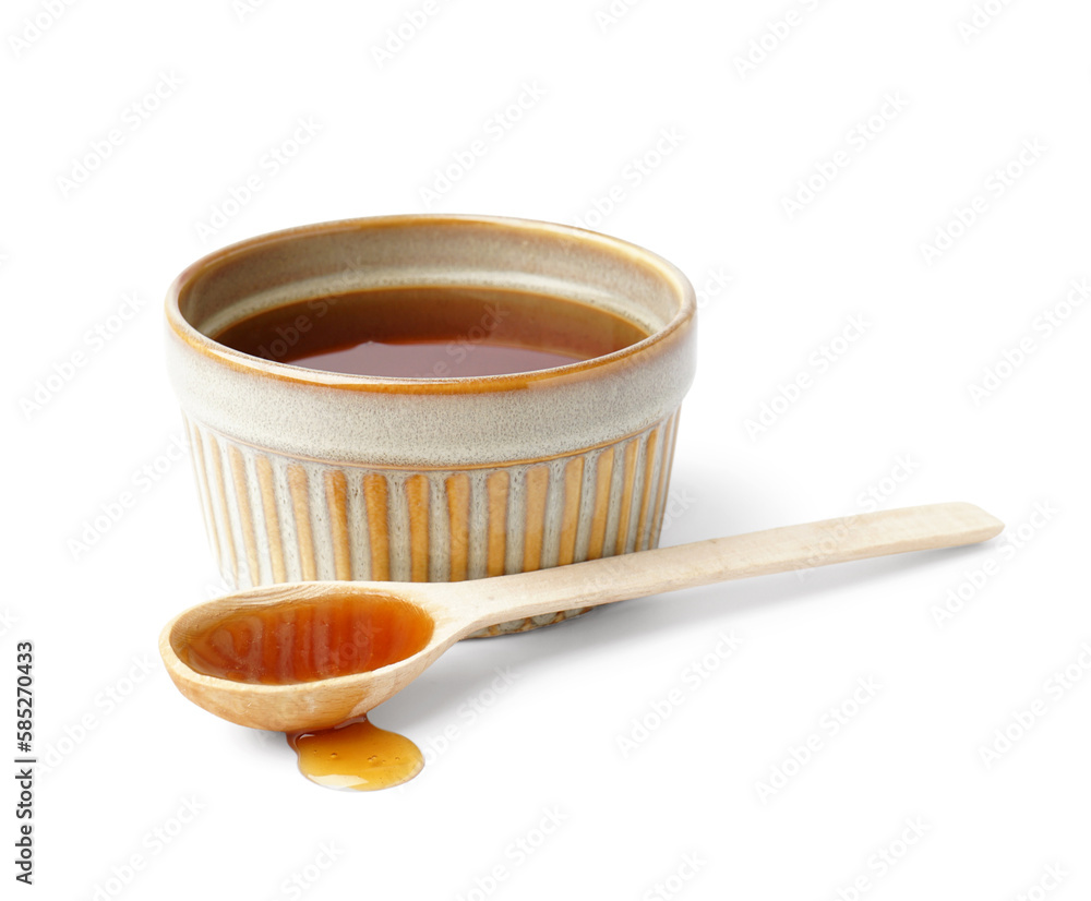 Wall mural bowl and spoon of tasty maple syrup on white background