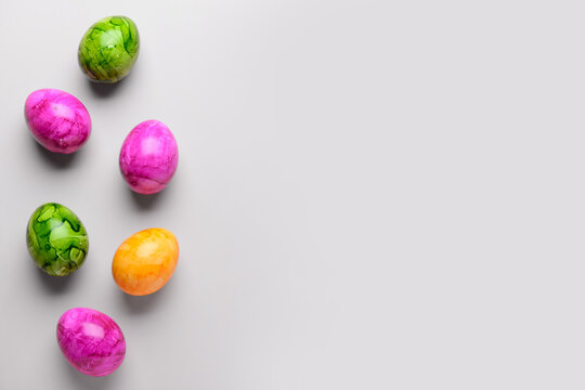 Painted Easter eggs on light background