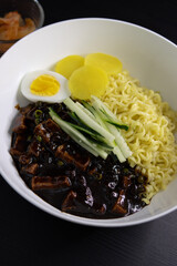 Jajangmyeon Instant Noodle With Black Bean Sauce, Kimchi, Cucumber, Pickled Radish - Closeup