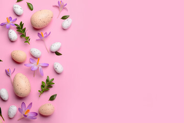 Composition with Easter eggs, beautiful crocus flowers and plant leaves on pink background