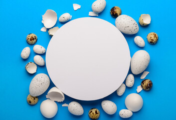 Composition with blank greeting card and Easter eggs on blue background
