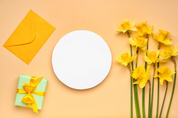 Beautiful narcissus, envelope, gift box and round blank card on color background