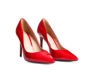 Pair of red high heeled shoes on white background