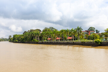 Fototapeta na wymiar buildings and trees along Sungai Temburong river in the Temburong District in Brunei Darussalam