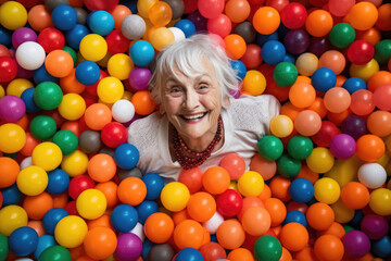 Fototapeta na wymiar an old woman with colorful plastic balls playground. AI generative image.