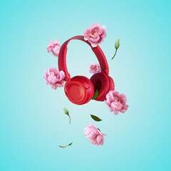 Red headphones and flowers levitating on blue background. Music, flowers, spring background. Creative spring or music minimal arrangement