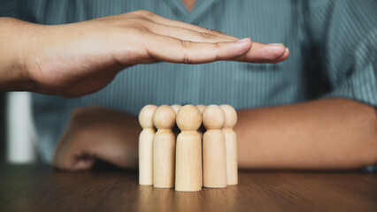 Hand choose wooden doll stand group teamwork concept of relationship or HR human resources officer or business team and personnel management job performance.