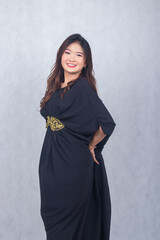 Fototapeta premium Asian chinese muslim headscarf hijab woman greeting ramadan fasting eid al fitr and eid al adha on white background. girl smiling expression her hand holding the back dress tail