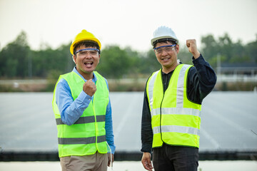Two Engineer worker working together at Solar panel.