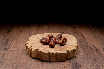 Many Date Palms are on bowls and cups of water and the Quran is on wooden tables, to wait for the time of Iftar, with the concept of ramadan Muslims around the world.