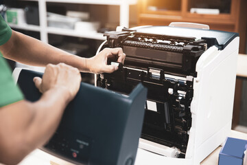 Technician hand open cover photocopier or photocopy to fix repair copier paper jam and replace ink...