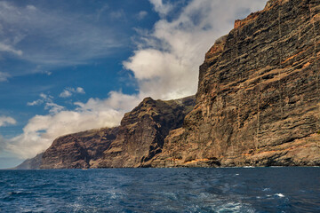 Fototapeta na wymiar View from the deck of the yacht to the cliffs called Los Gigantes, Tenerife, Canary Islands, Spain